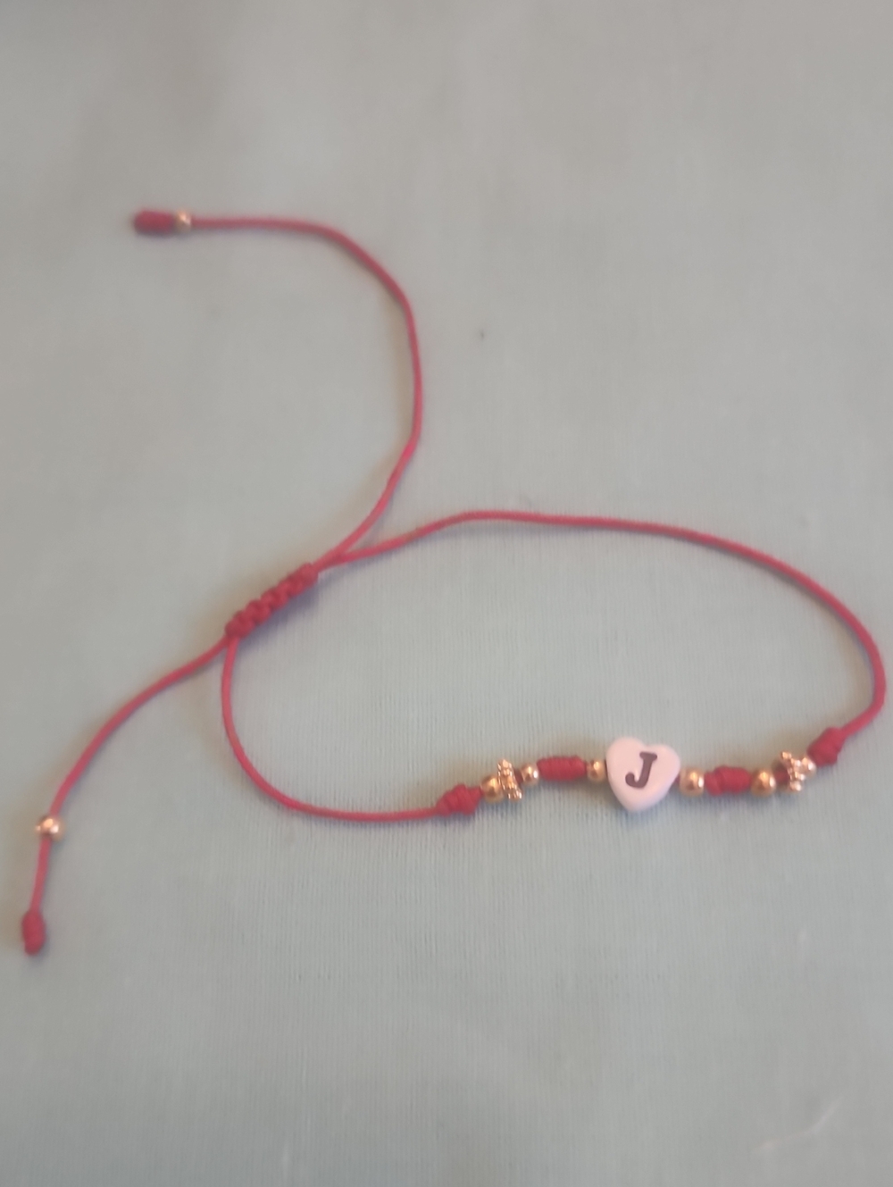 Adjustable Red Cord Bracelet with 'J' Heart Charm and Gold Accents